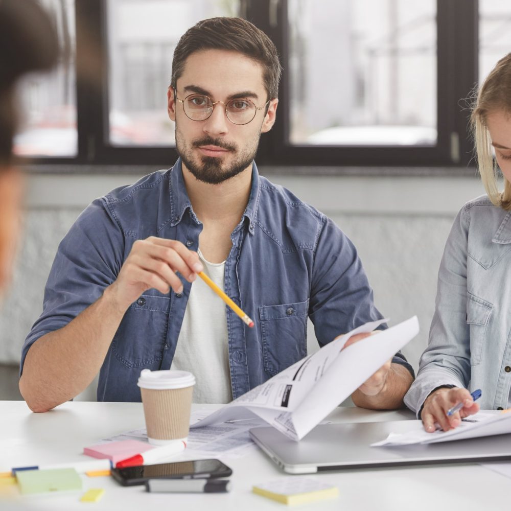 young-colleagues-have-formal-meeting-discuss-solutions-study-documents-prepare-marketing-project-.jpg young-colleagues-have-formal-meeting-discuss-solutions-study-documents-prepare-marketing-project-.jpg